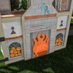 Casuta de joaca Cuptorul cu Lemne Kidkraft Cozy Hearth - Casa cu LEDuri pentru copii cu pridvor si bancute cu bucatarie si accesorii Cabin PlayHouse